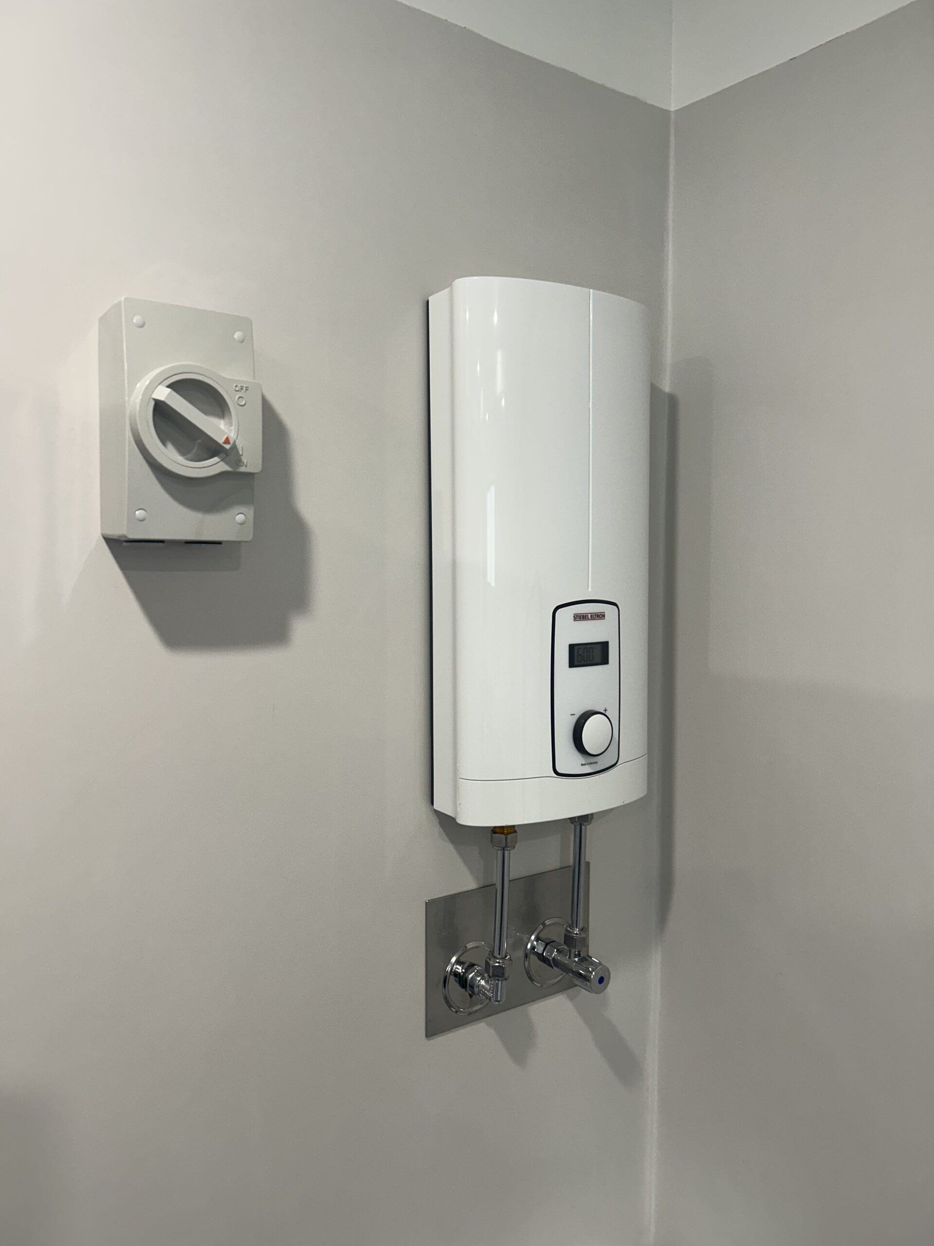 Electrical switch installation Brisbane featuring a modern water heater system