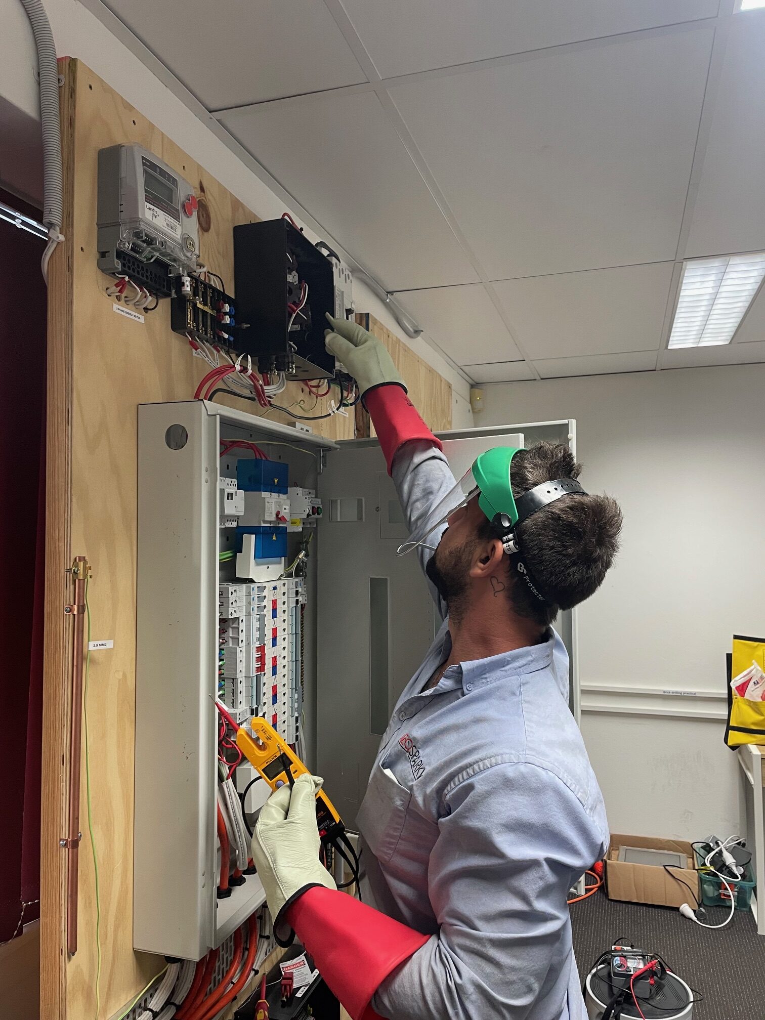 SEQ Sparky electrician performing switchboard maintenance in Brisbane