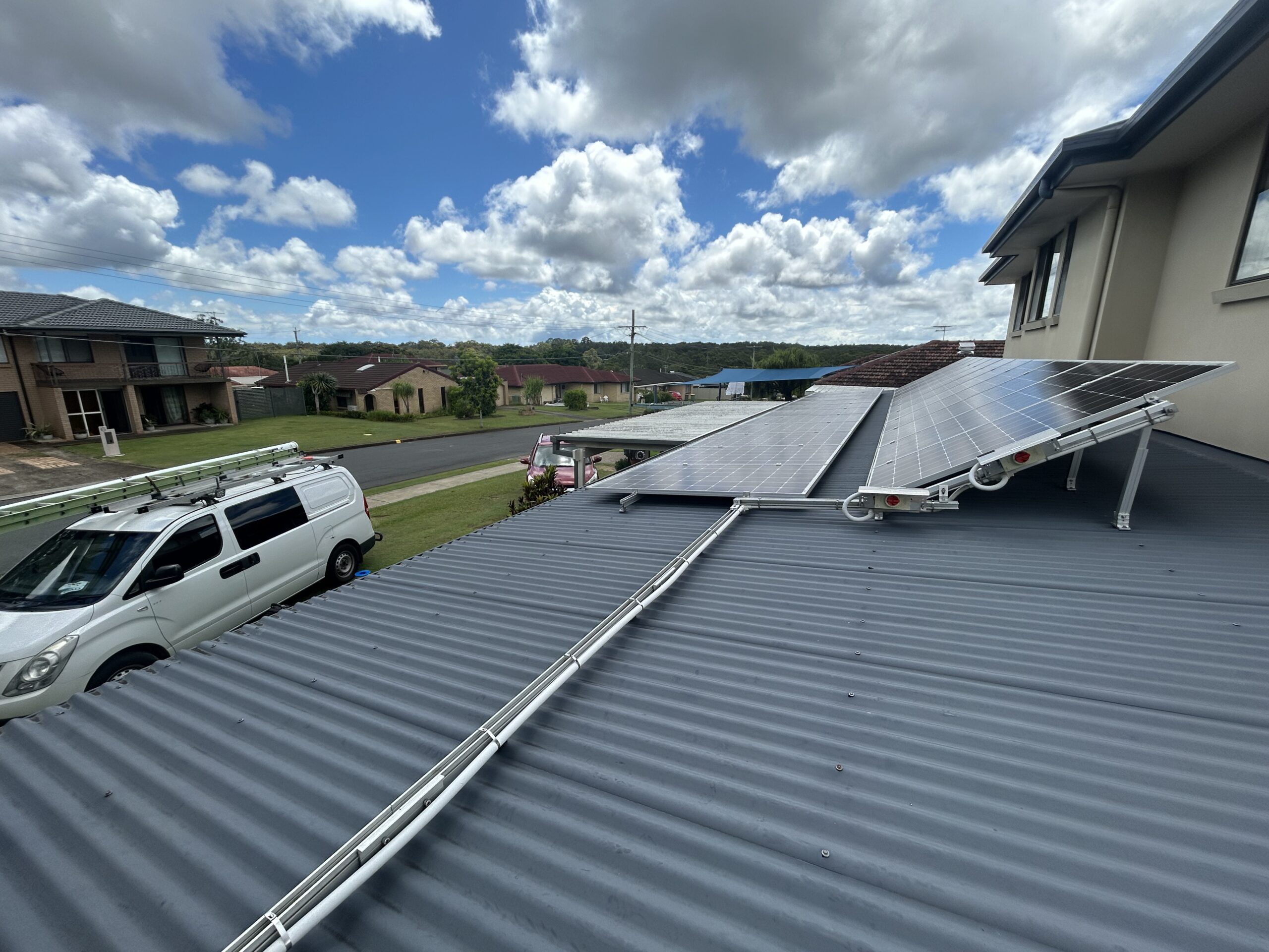 Solar panel installation on a residential roof with SEQSparky van in the background in Brisbane