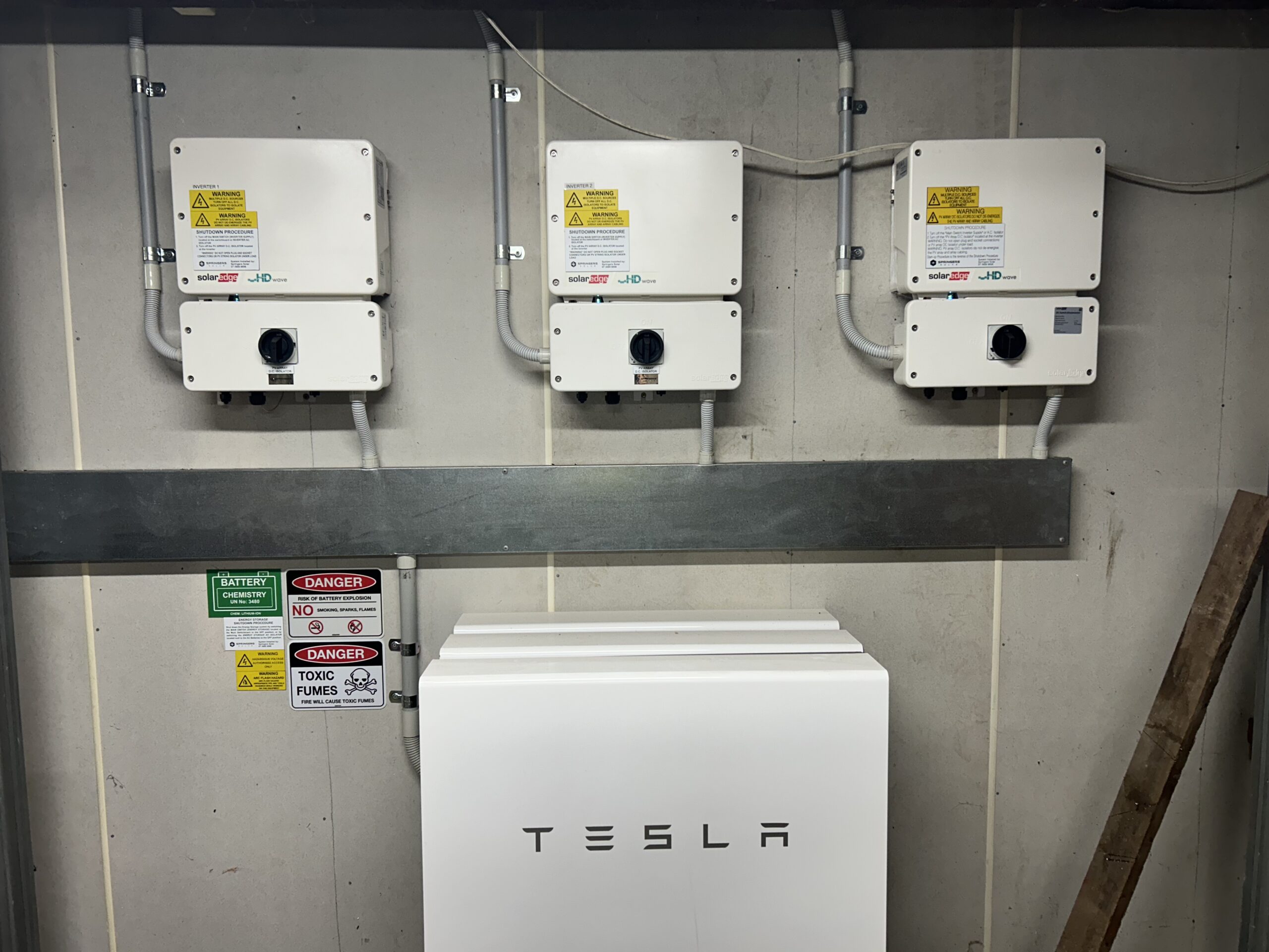 Tesla battery backup with three solar inverters installed by SEQSparky in Brisbane