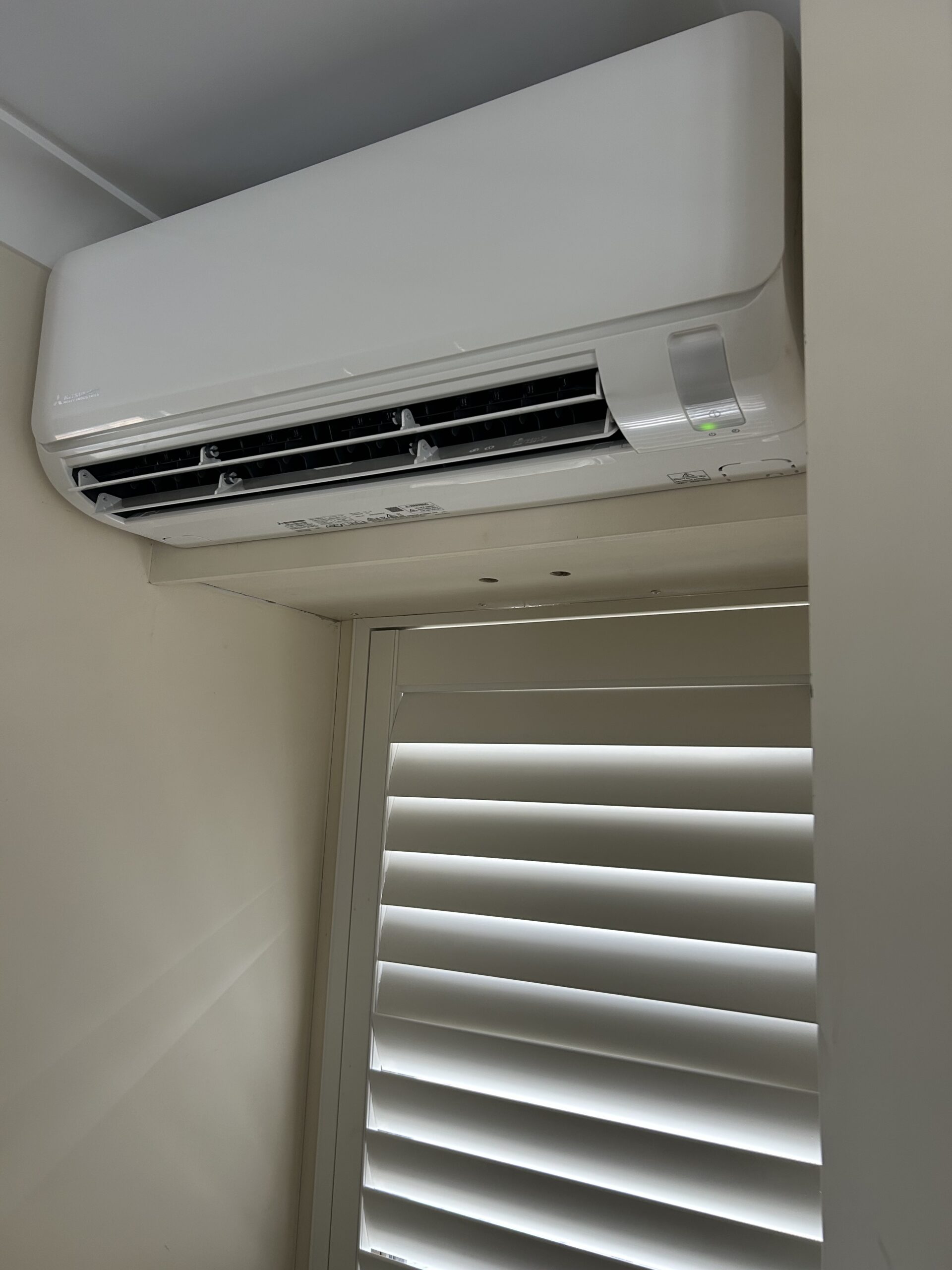 Newly installed split system air conditioner in a Brisbane home by SEQ Sparky