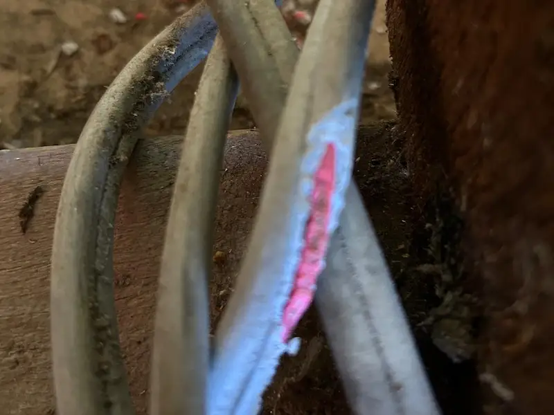 Cracked and deteriorated cable insulation exposing conductor wiring showing why home rewiring is needed