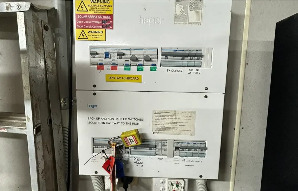 Modern Hager RCBO switchboard in Brisbane finished by SEQ Sparky with multiple supply warning stickers tagged labels and clean cable management compliant with Queensland Electrical Safety Regulation